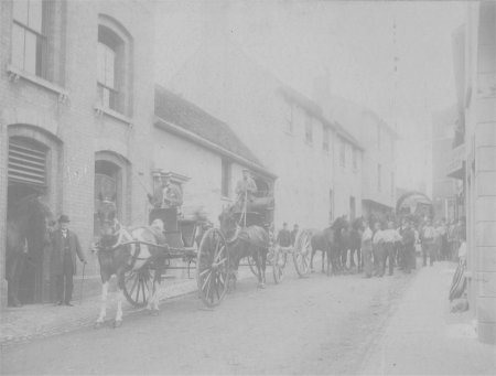 Horse and carts and people gathered