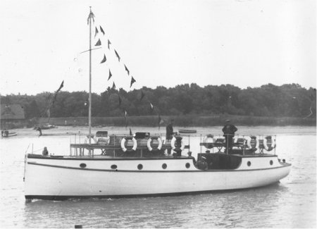Boat on river with bunting from mast