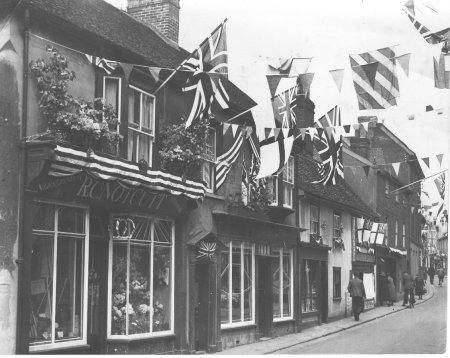 Notcutt's shop in street with Union Jack flags