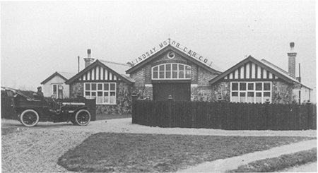 Three buildings and motor car