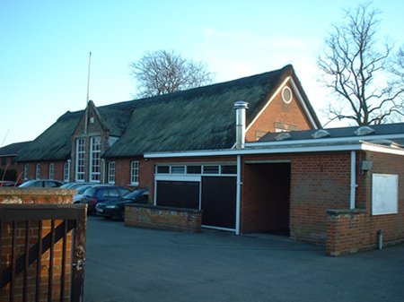 Thatched building with carpark