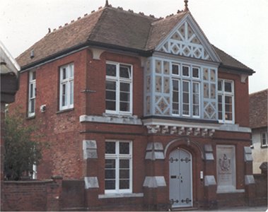Brick house with ornate wooden window frontage
