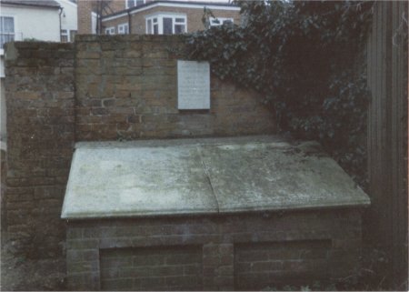 Plaque and raised stone tomb