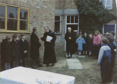 Reverend and people gathered in garden