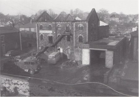 Mill after fire damage and fire engine