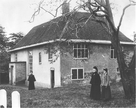 Large house with ladies in garden